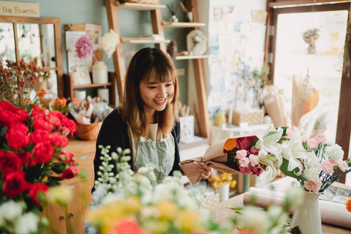 A florist arranging flowers in her shop