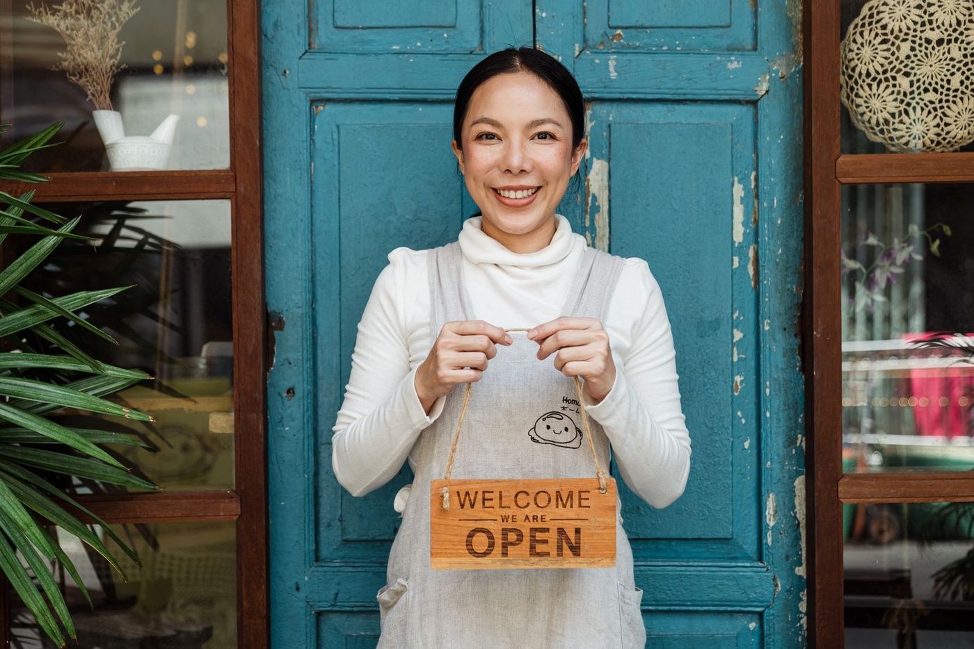 A small business owner opening up her premises for the day